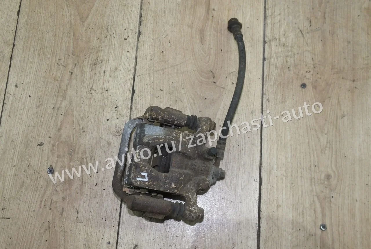 Суппорт тормозной задний левый Nissan Qashqai J10