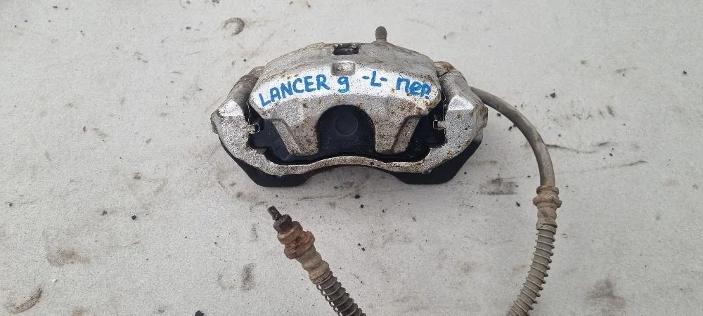 Суппорт передний левый Mitsubishi Lancer 9