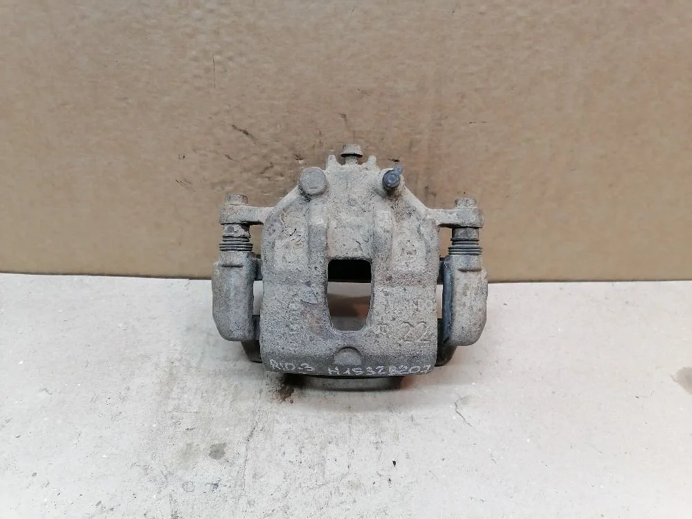 Суппорт тормозной передний левый Kia Rio III (2011—2015) 581104L000