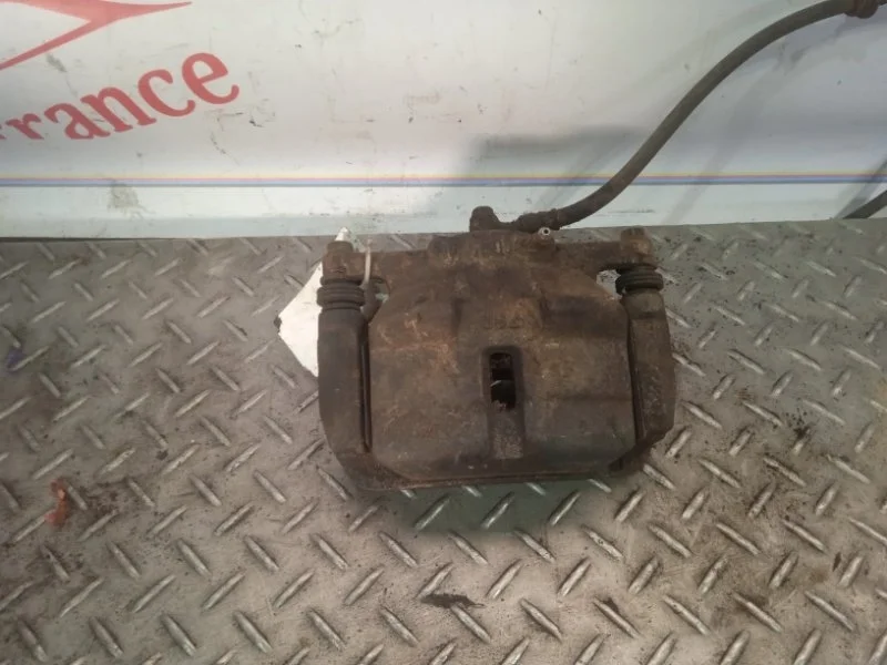 Суппорт тормозной Nissan X-trail 41011JD00A T31, передний левый