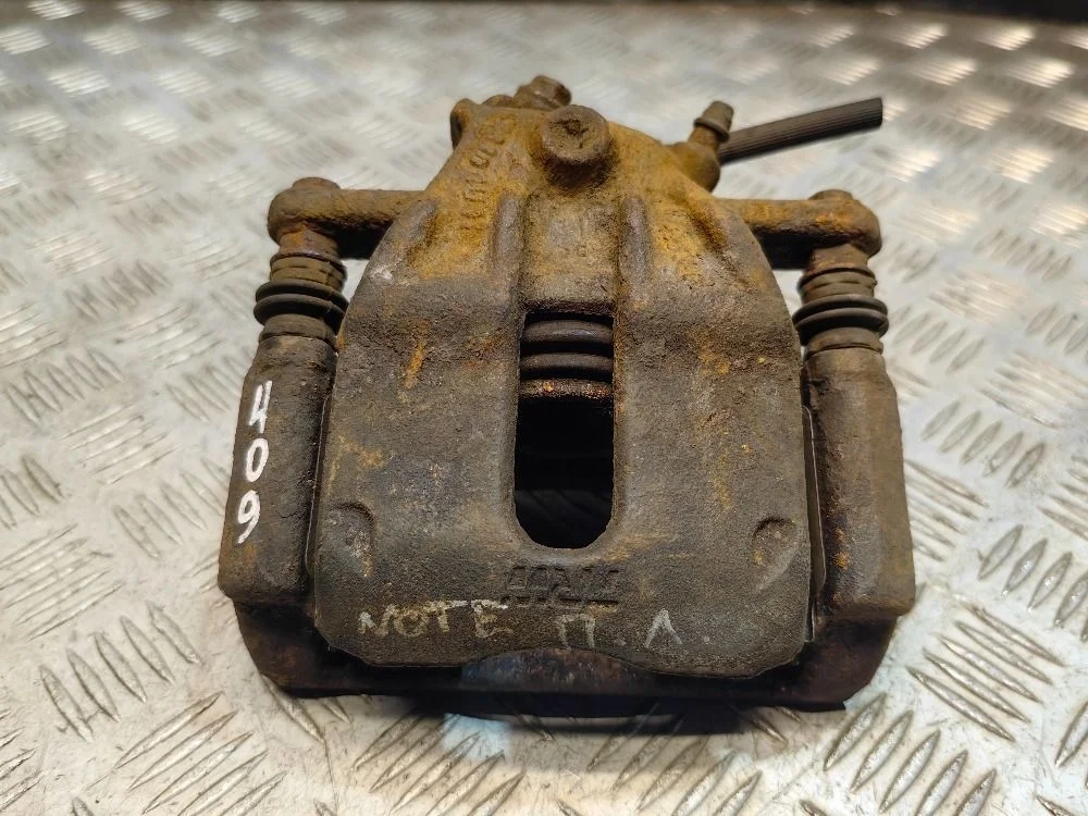 Суппорт тормозной передний левый Nissan Note E11