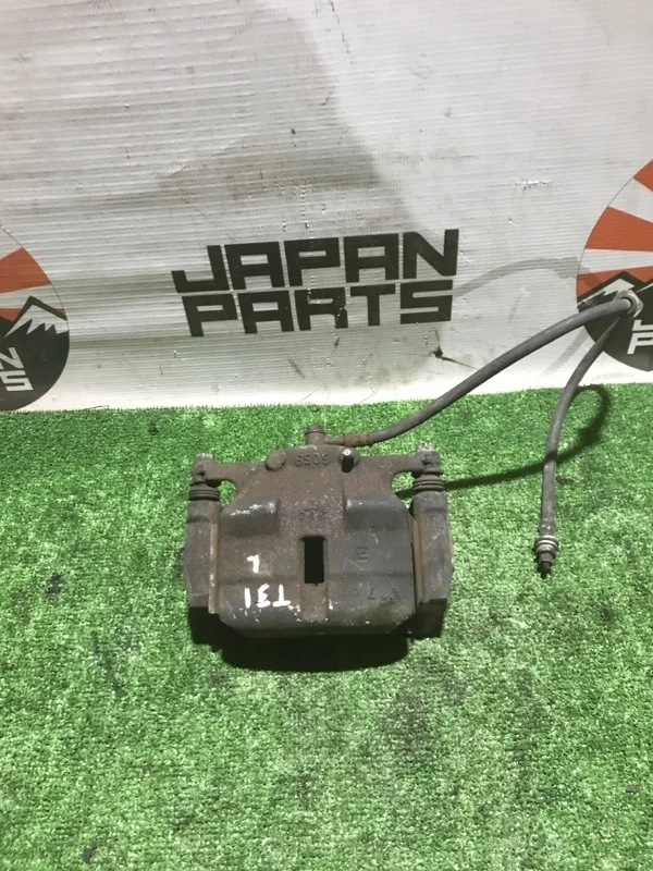 Тормозной суппорт Nissan X-Trail 41011JD00A T31, передний левый