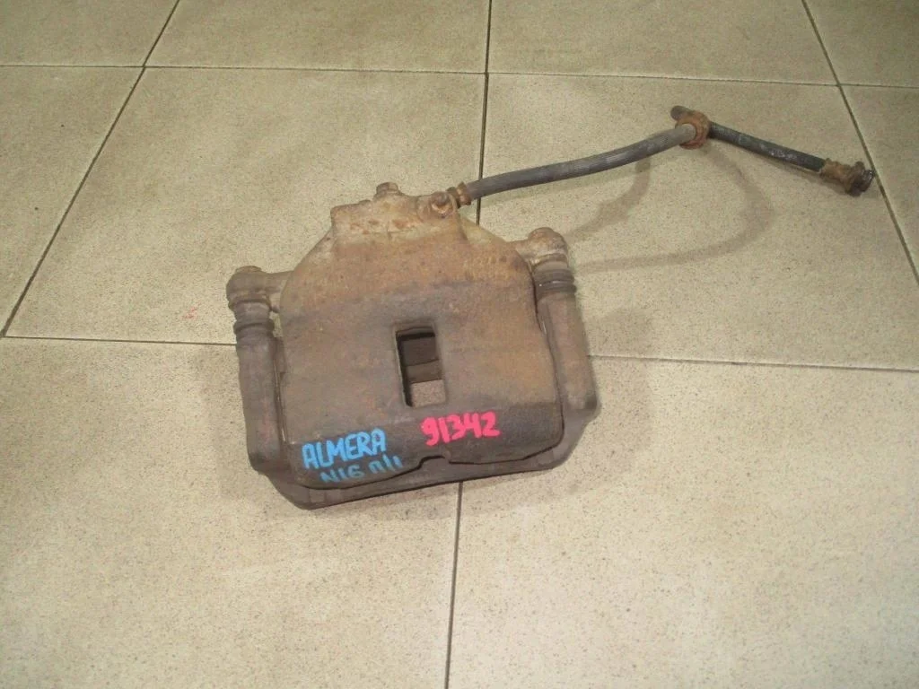 Суппорт передний левый Nissan Almera N16