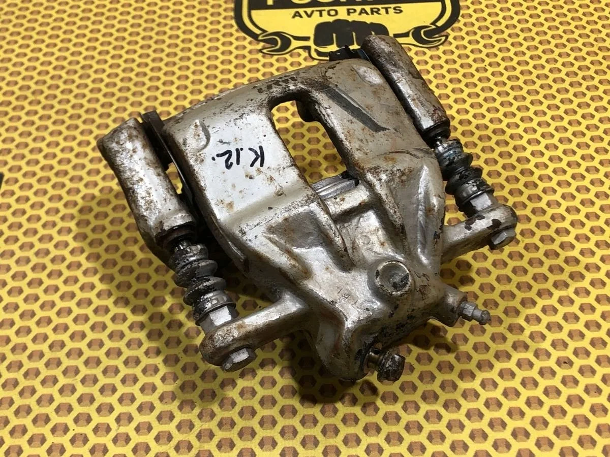 Суппорт Nissan Micra 41001AX60A, передний правый