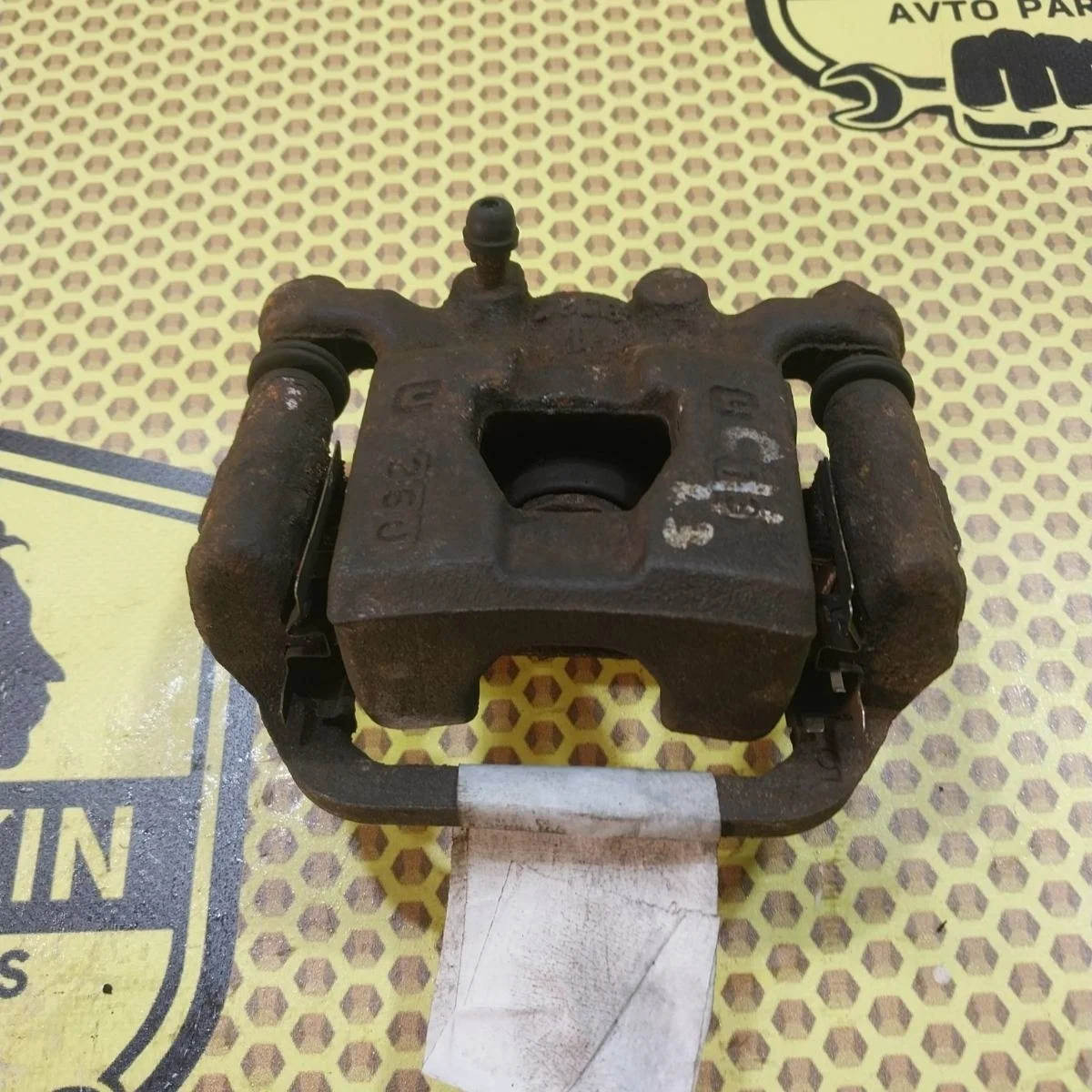 Суппорт Nissan Tiida 2009 44011EM11A SC11X, задний левый