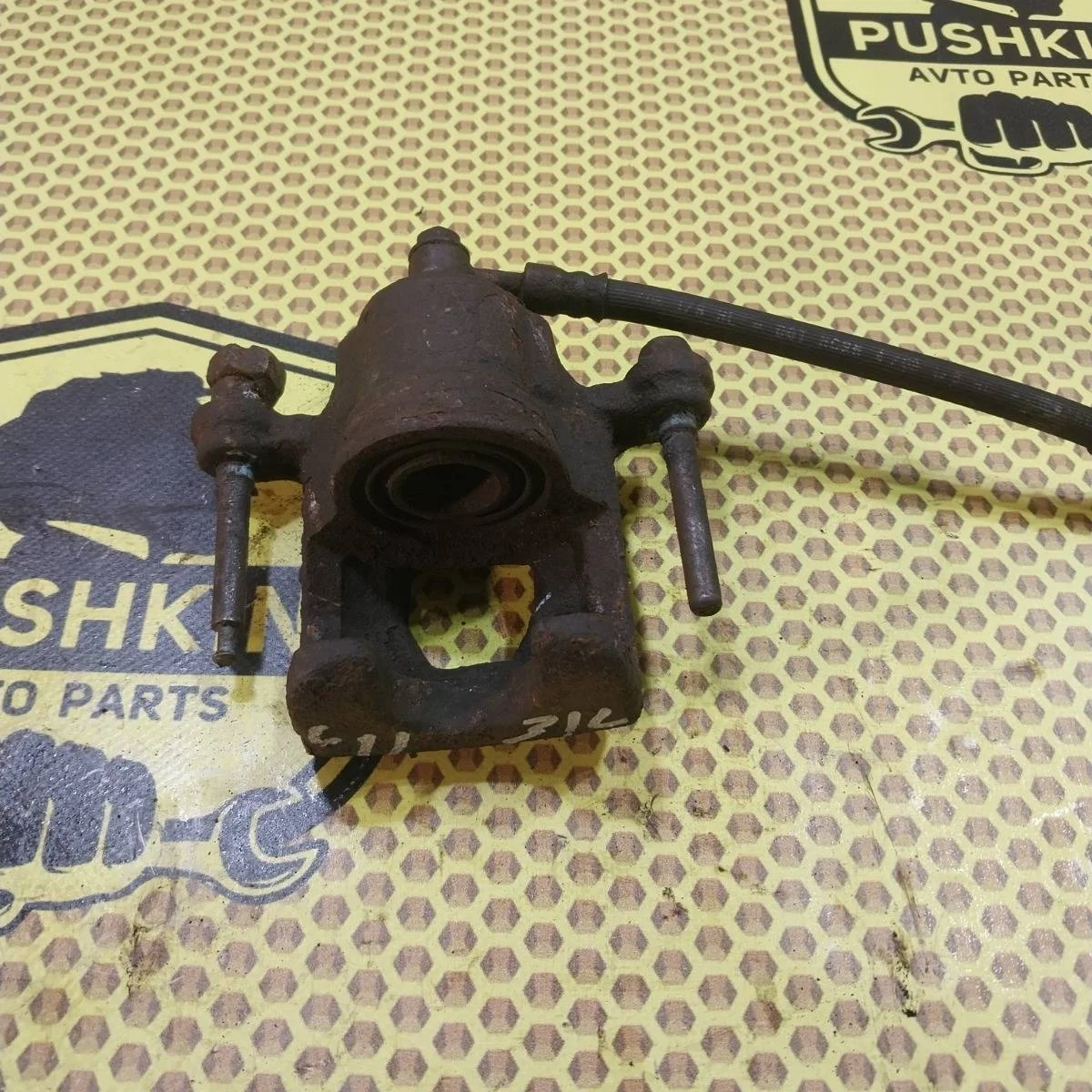 Суппорт Nissan Tiida 2009 44011EM11A SC11X, задний левый