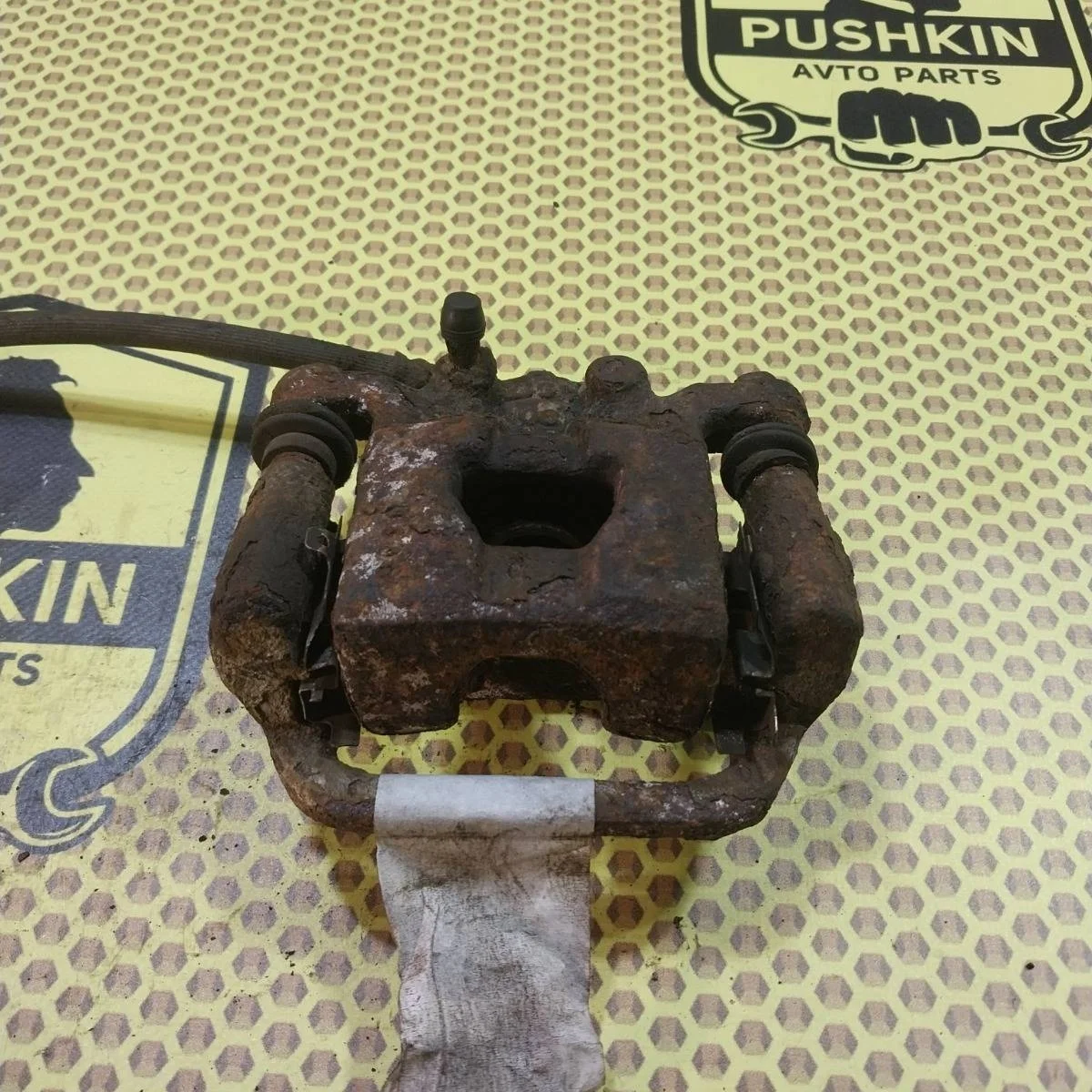 Суппорт Nissan Tiida 2009 44011EM11A SC11X, задний левый