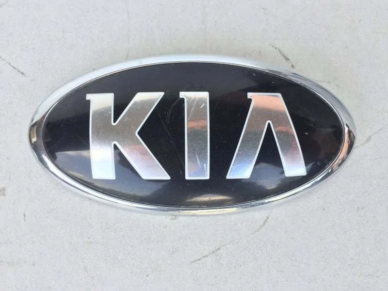 Эмблема Kia K5 2012-2018 86310A2000 3, передняя