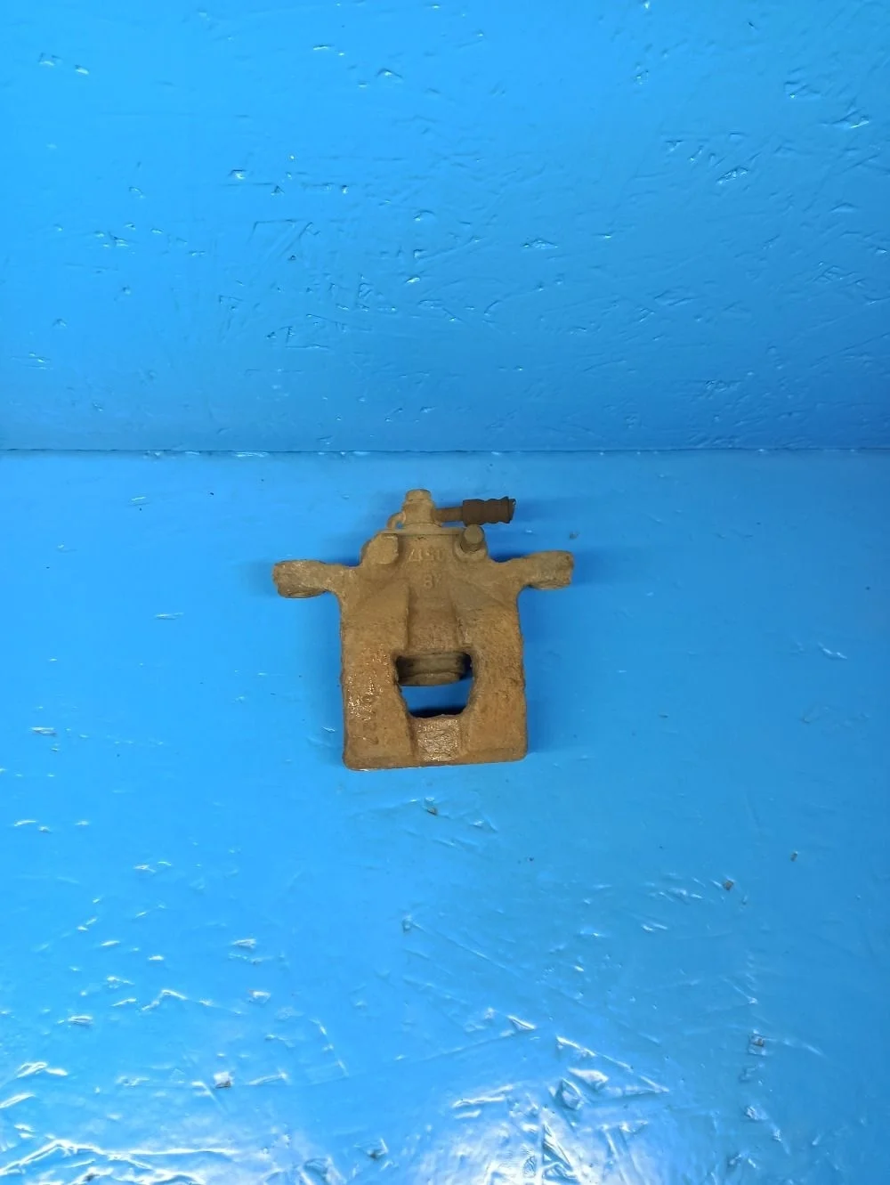 Суппорт тормозной задний левый Nissan Tiida C11 (2004—2012)