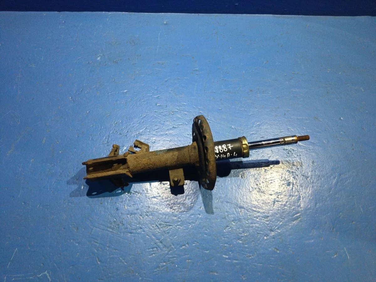 Амортизатор передний левый Nissan Note E11 (2005—2009)