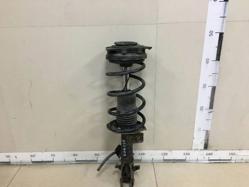 Амортизатор передний левый Nissan Tiida (C11) 2007-2014