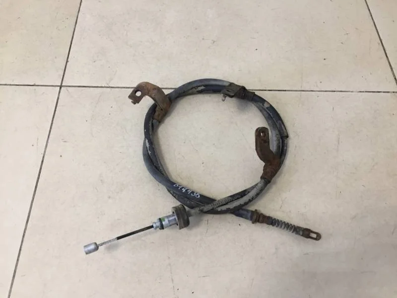 Трос стояночного тормоза левый Kia Rio 3 (UB) 2011-2017