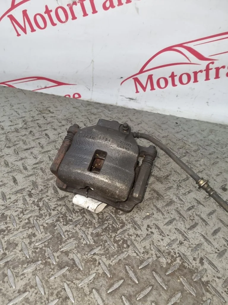 Суппорт тормозной Nissan Almera 410112F522 N16, передний левый