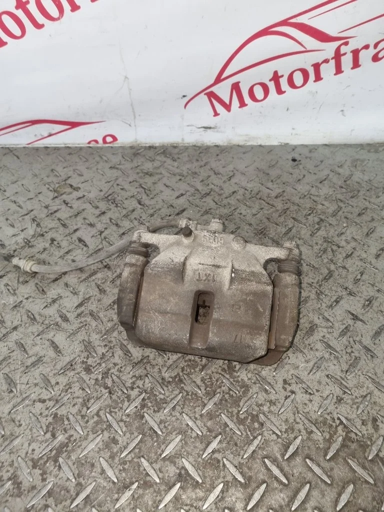 Суппорт тормозной Nissan X-trail 41011JD00A T31, передний левый