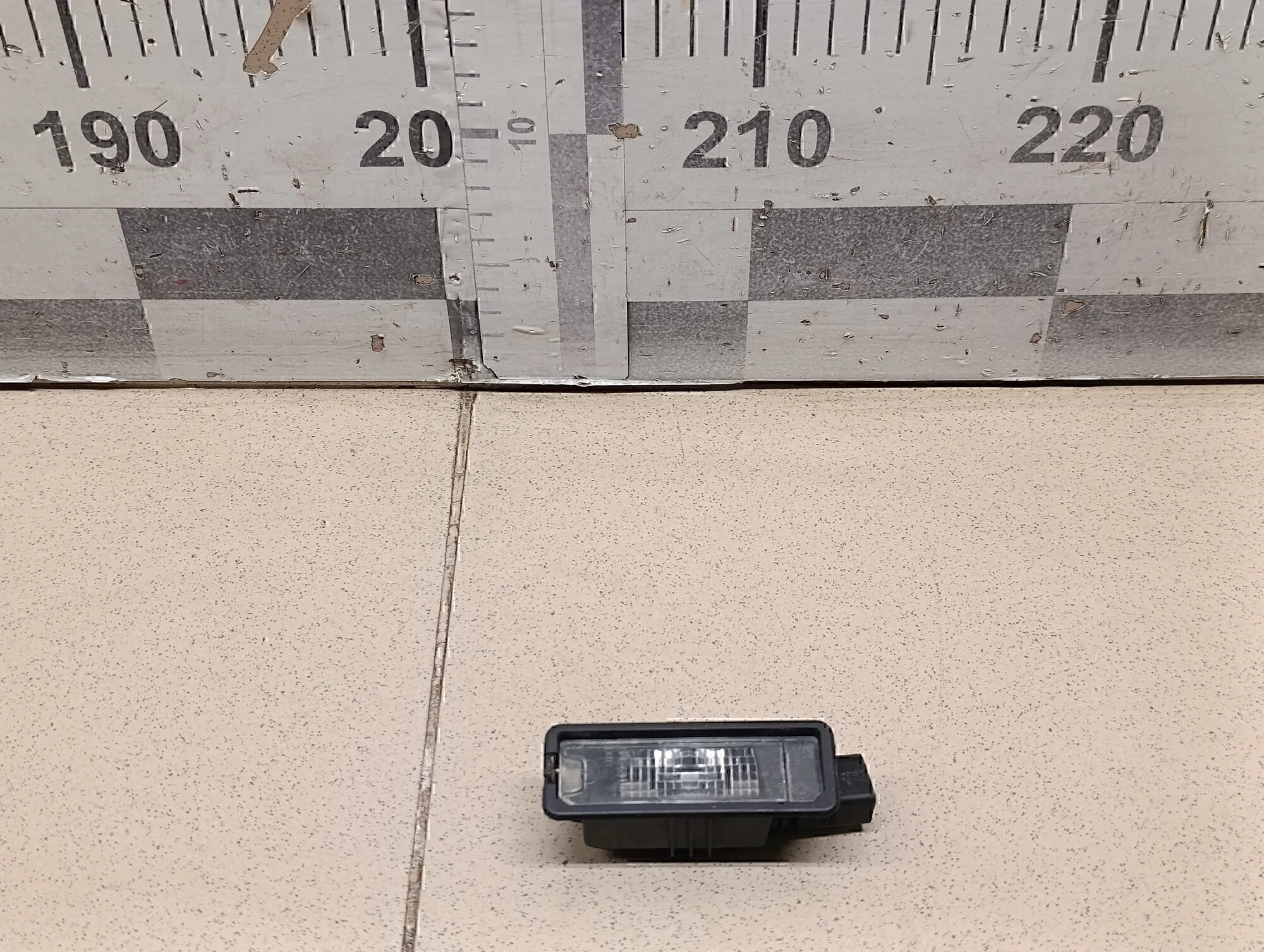 Фонарь подсветки номера Golf VII 2012>