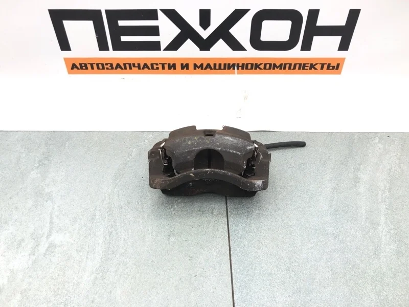 Суппорт тормозной NISSAN QASHQAI 410114EA0A J11E, передний левый