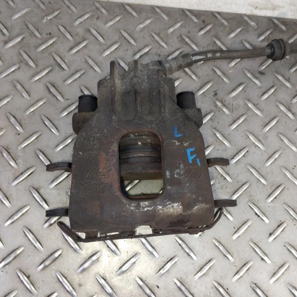 Суппорт тормозной Ford Focus 1   F L